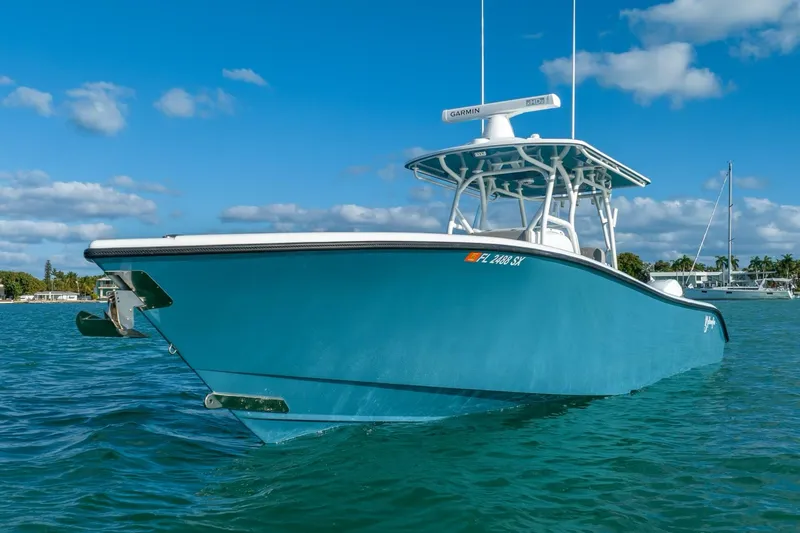 Slide: The Image of 2025 Yellowfin 32 boat on clear blue water under a sunny sky. - 6