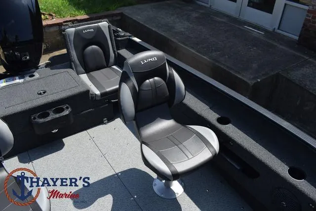 Slide: The Image of 2025 Lund 1675 Adventure SS boat interior with seating, Thayer's Marine logo. - 21