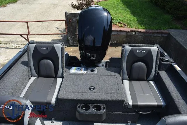 Slide: The Image of 2025 Lund 1675 Adventure SS boat interior with two seats and motor. - 33