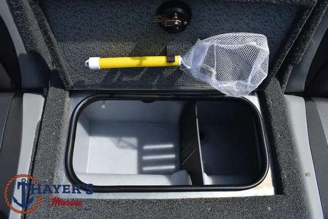 Slide: The Image of 2025 Lund 1675 Adventure SS boat storage compartment with net and Thayer's Marine logo. - 34