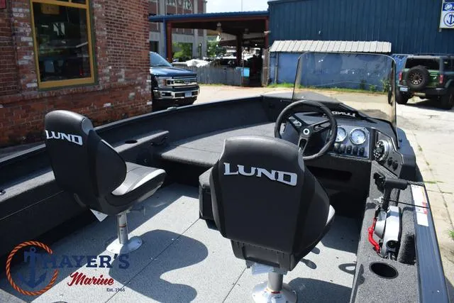Slide: The Image of 2025 Lund 1675 Adventure SS boat interior with two seats and steering console. - 36