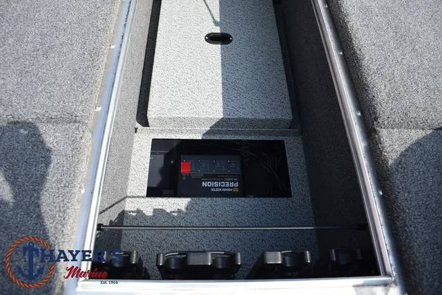 Slide: The Image of 2025 Lund 1875 Pro-V Bass XS boat storage compartment with Precision charger. - 17