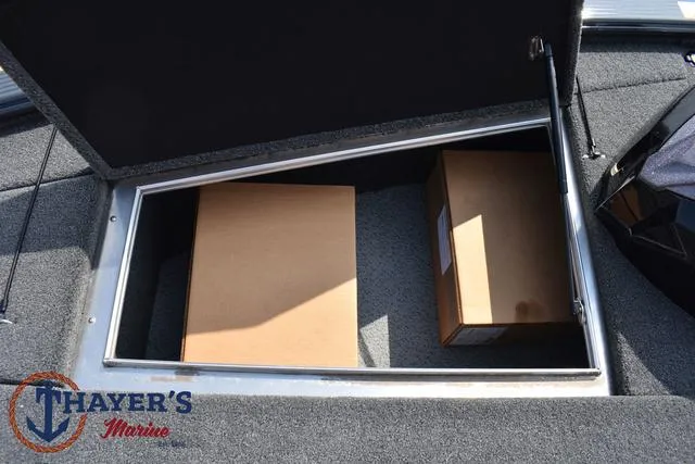 Slide: The Image of Storage compartment of 2025 Lund 1875 Pro-V Bass XS boat with boxes inside. - 19