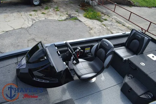 Slide: The Image of 2025 Lund 1875 Pro-V Bass XS boat interior with steering console and seating. - 23