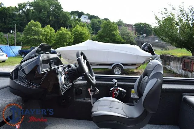 Slide: The Image of 2025 Lund 1875 Pro-V Bass XS boat interior with steering wheel and seat. - 27