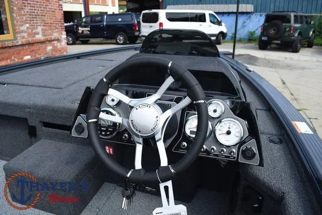 Slide: The Image of 2025 Lund 1875 Pro-V Bass XS boat dashboard with steering wheel and gauges. - 28