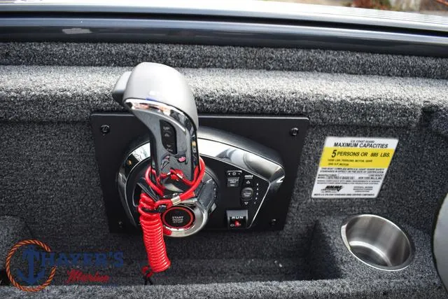 Slide: The Image of 2025 Lund 1875 Pro-V Bass XS boat control panel with throttle and capacity label. - 29
