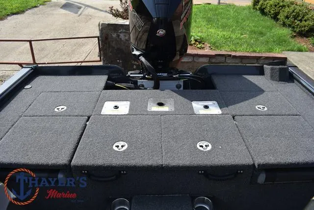 Slide: The Image of 2025 Lund 1875 Pro-V Bass XS boat deck with storage compartments and motor. - 37