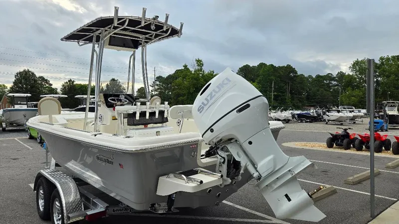 Slide: The Image of 2025 Bulls Bay 2200 boat with Suzuki outboard motor on trailer in parking lot. - 3