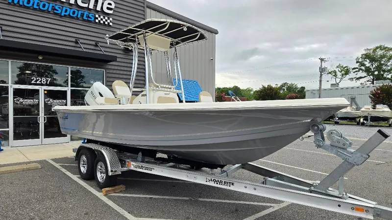 Slide: The Image of 2025 Bulls Bay 2200 boat on a trailer outside a dealership. - 6