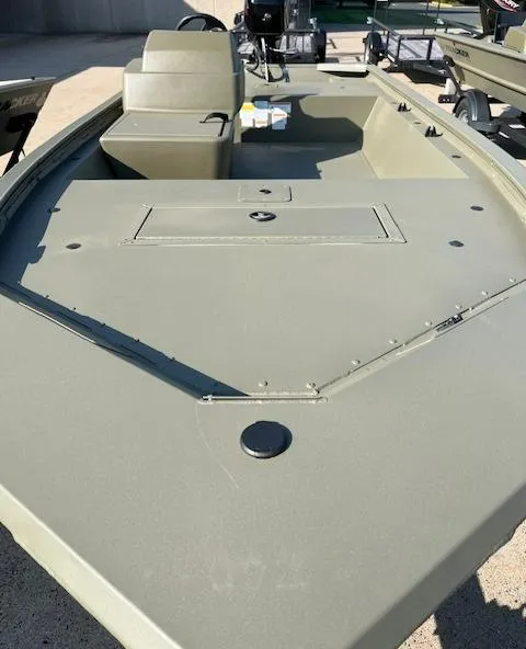 Slide: The Image of 2024 Tracker Grizzly 1648 SC boat, olive green, spacious deck, seating area. - 2