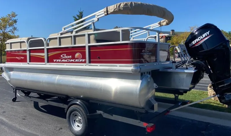 Slide: The Image of 2024 Sun Tracker Party Barge 18 DLX pontoon boat with Mercury outboard engine. - 2
