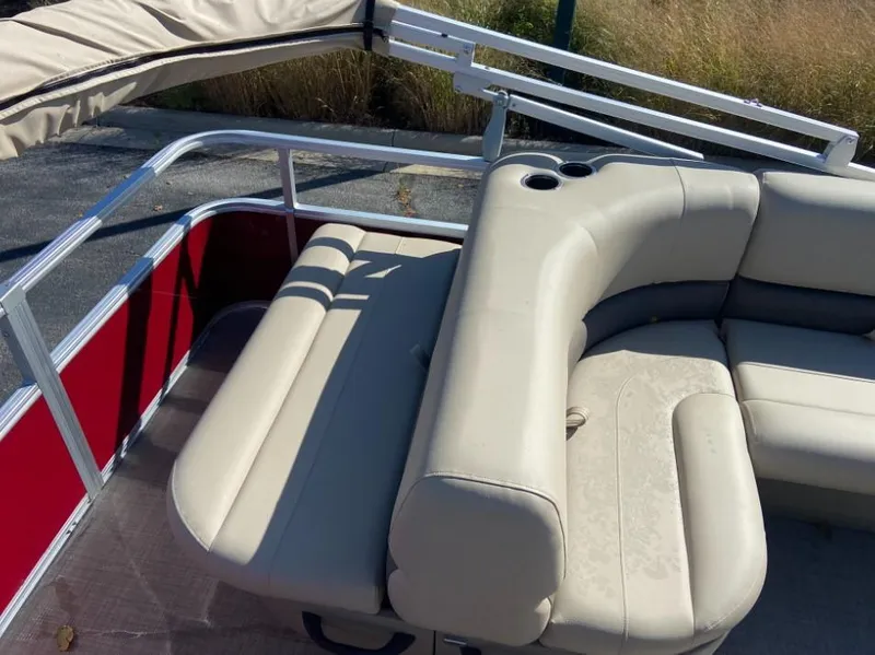 Slide: The Image of Sun Tracker Party Barge 18 DLX 2024 interior seating with cup holders. - 6