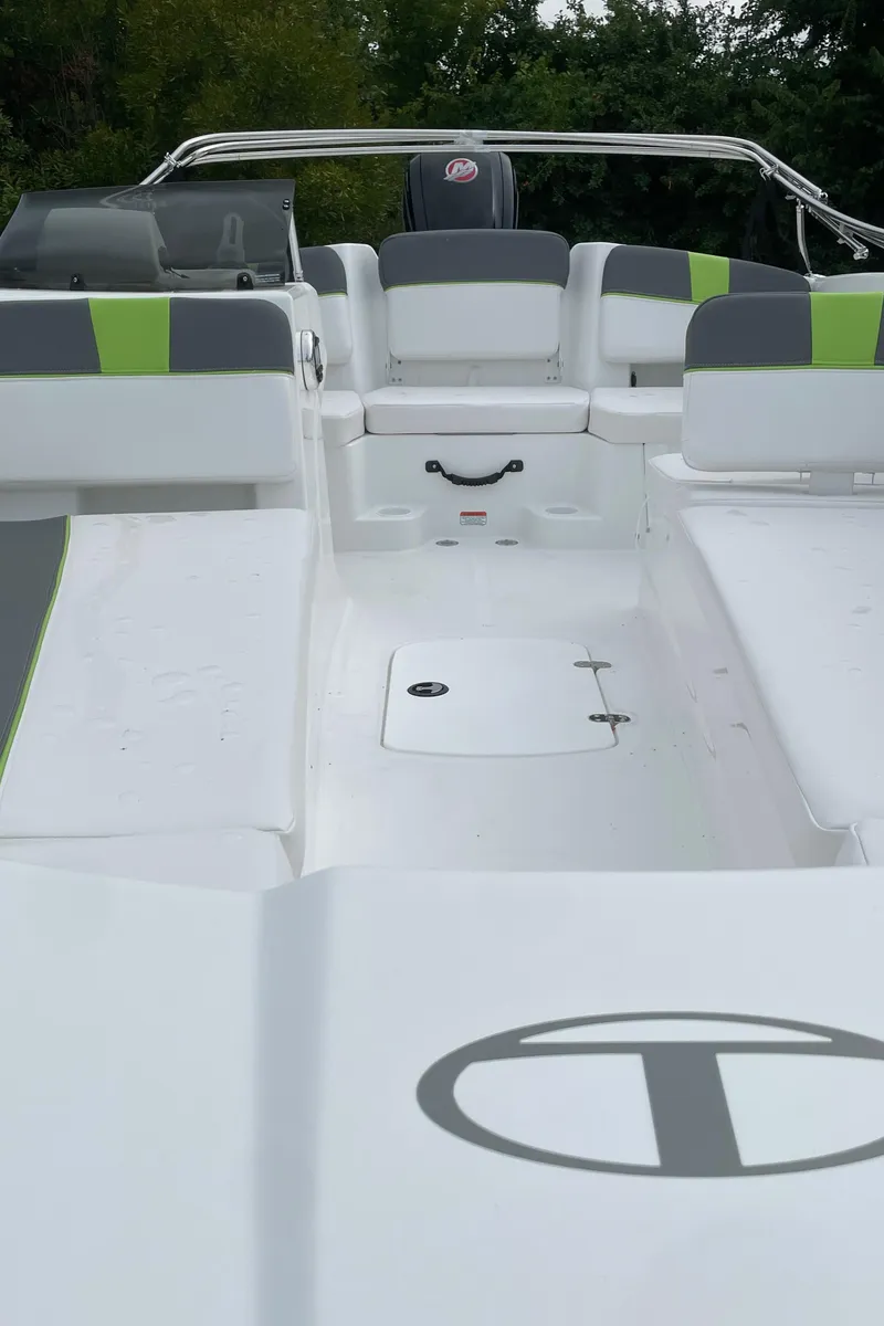 Slide: The Image of 2024 Tahoe T18 boat interior with green and gray seating. - 2