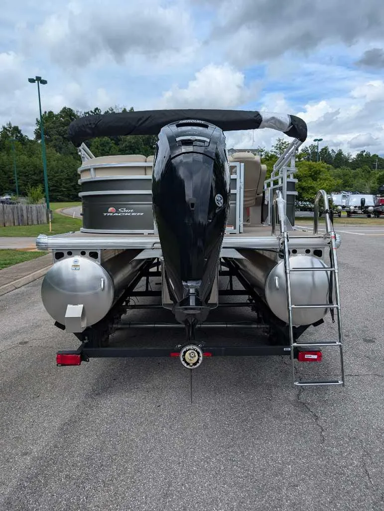 Slide: The Image of 2024 Sun Tracker Party Barge 20 DLX pontoon boat rear view on trailer. - 3