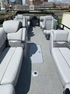 Slide: The Image of 2024 Regency 230 DL3 pontoon boat with spacious seating and modern design. - 3