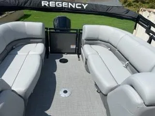 Slide: The Image of 2024 Regency 230 DL3 pontoon boat with spacious seating and sleek design. - 4