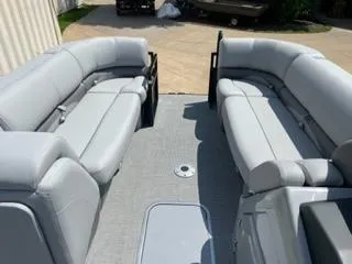 Slide: The Image of 2024 Regency 230 DL3 pontoon boat interior with spacious seating and modern design. - 5