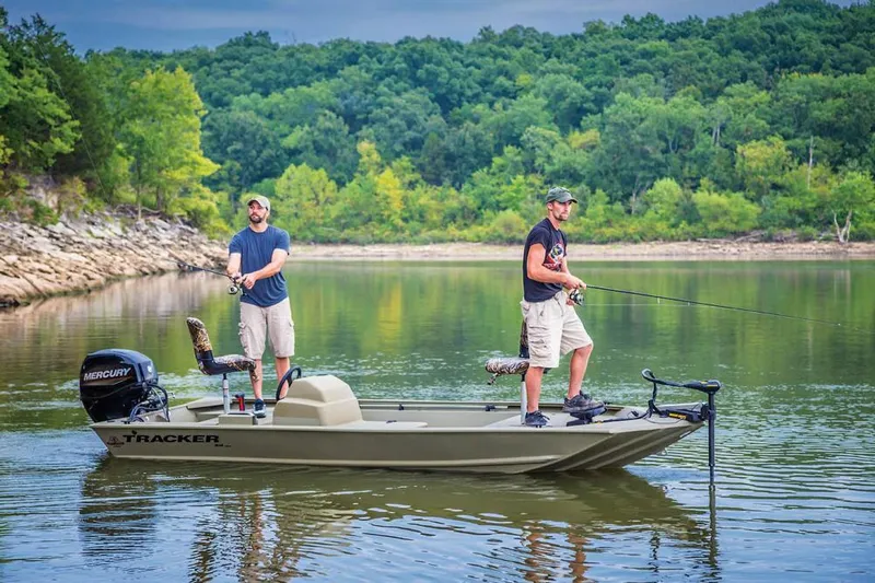 Slide: The Image of 2024 Tracker Grizzly 1648 SC boat with camouflage interior, docked outdoors. - 4