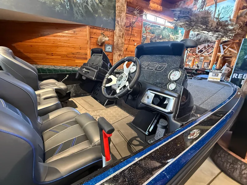 Slide: The Image of 2024 Nitro Z20 boat interior with steering wheel and seats in showroom. - 2