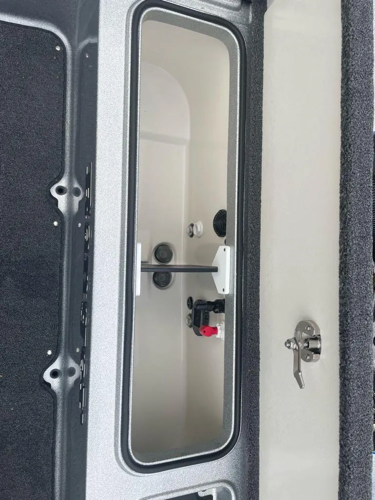 Slide: The Image of 2024 Ranger 621FS Pro boat storage compartment with secure latch. - 4