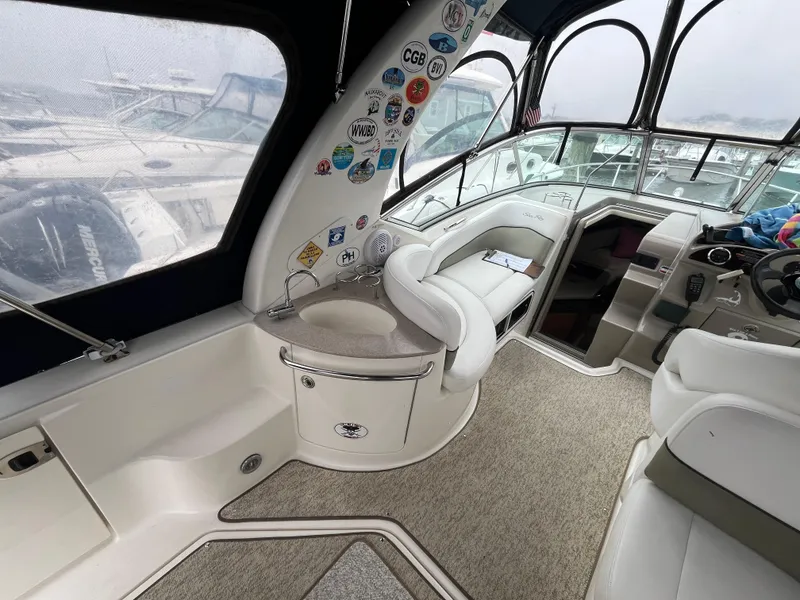Slide: The Image of Interior of a 2006 Sea Ray 260 Sundancer boat with seating and helm station. - 12