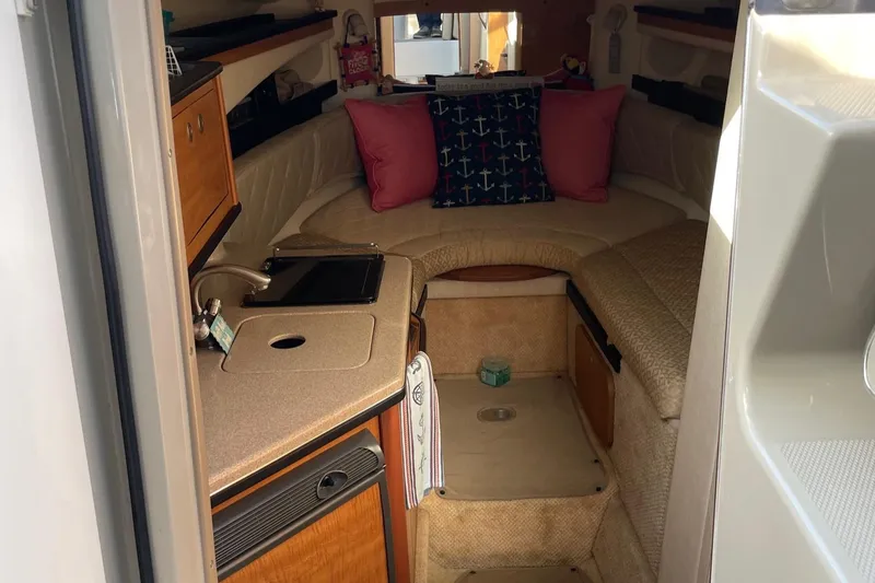 Slide: The Image of Interior cabin of a 2006 Sea Ray 260 Sundancer with kitchenette and seating area. - 13