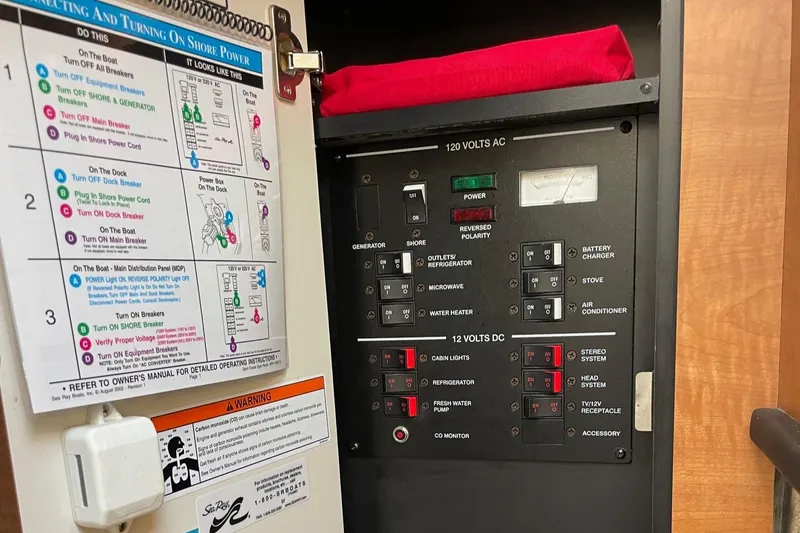Slide: The Image of Electrical control panel of a 2006 Sea Ray 260 Sundancer boat. - 14
