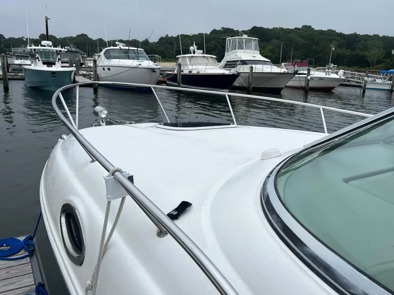 Slide: The Image of 2006 Sea Ray 260 Sundancer docked at a marina with other boats. - 3