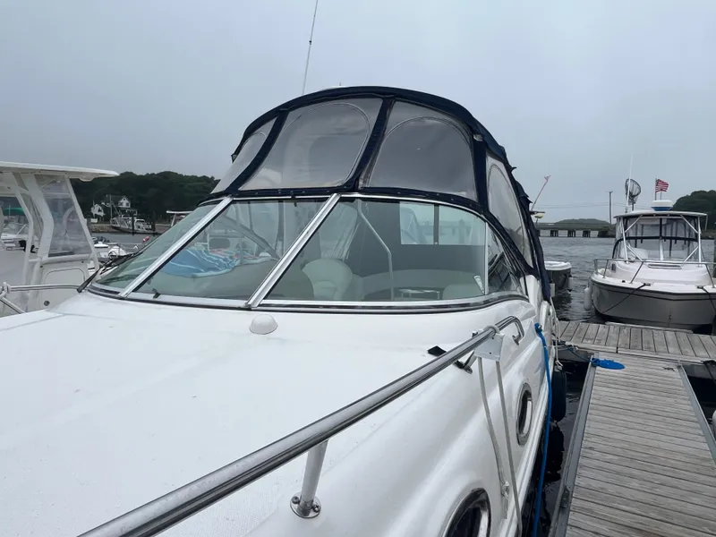 Slide: The Image of 2006 Sea Ray 260 Sundancer docked at a marina on a cloudy day. - 4