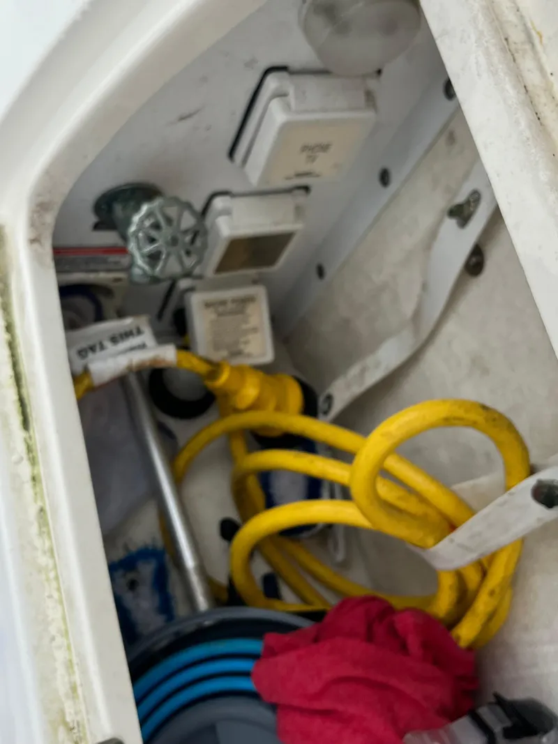 Slide: The Image of Electrical compartment of a 2006 Sea Ray 260 Sundancer with yellow power cables. - 41