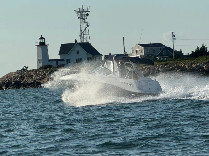 Slide: The Image of Sea Ray 260 Sundancer 2006 cruising near a lighthouse on a sunny day. - 5