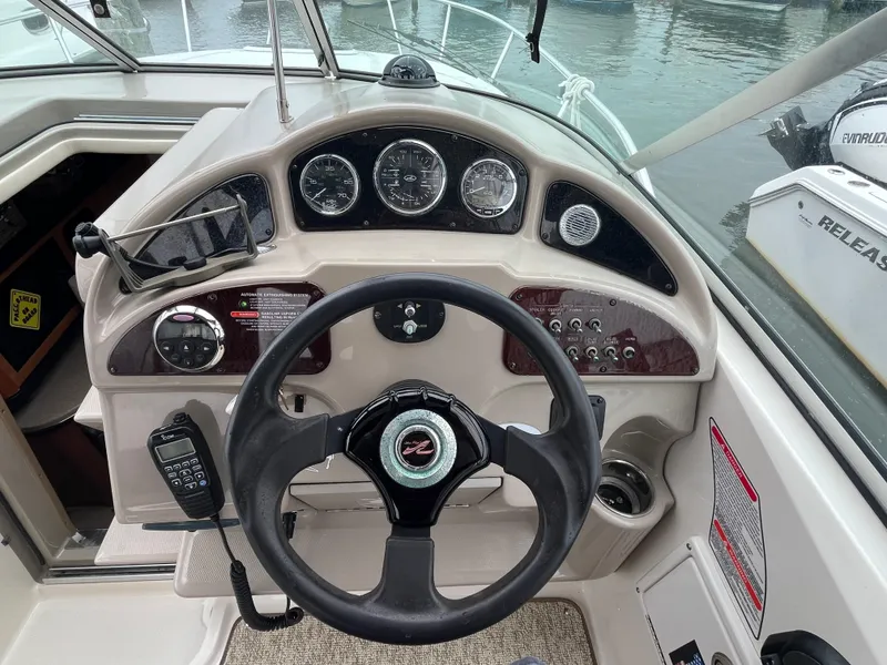 Slide: The Image of 2006 Sea Ray 260 Sundancer helm with steering wheel, gauges, and controls. - 8