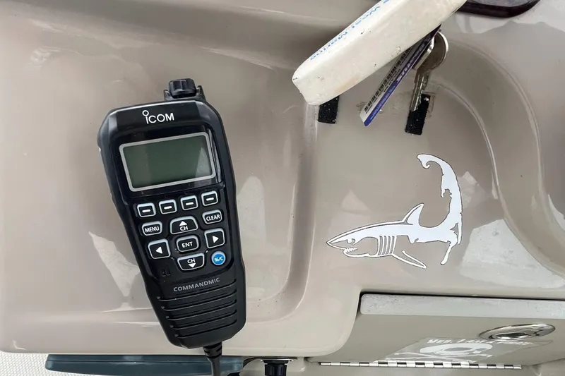Slide: The Image of ICOM marine radio on 2006 Sea Ray 260 Sundancer boat dashboard with shark decal. - 9