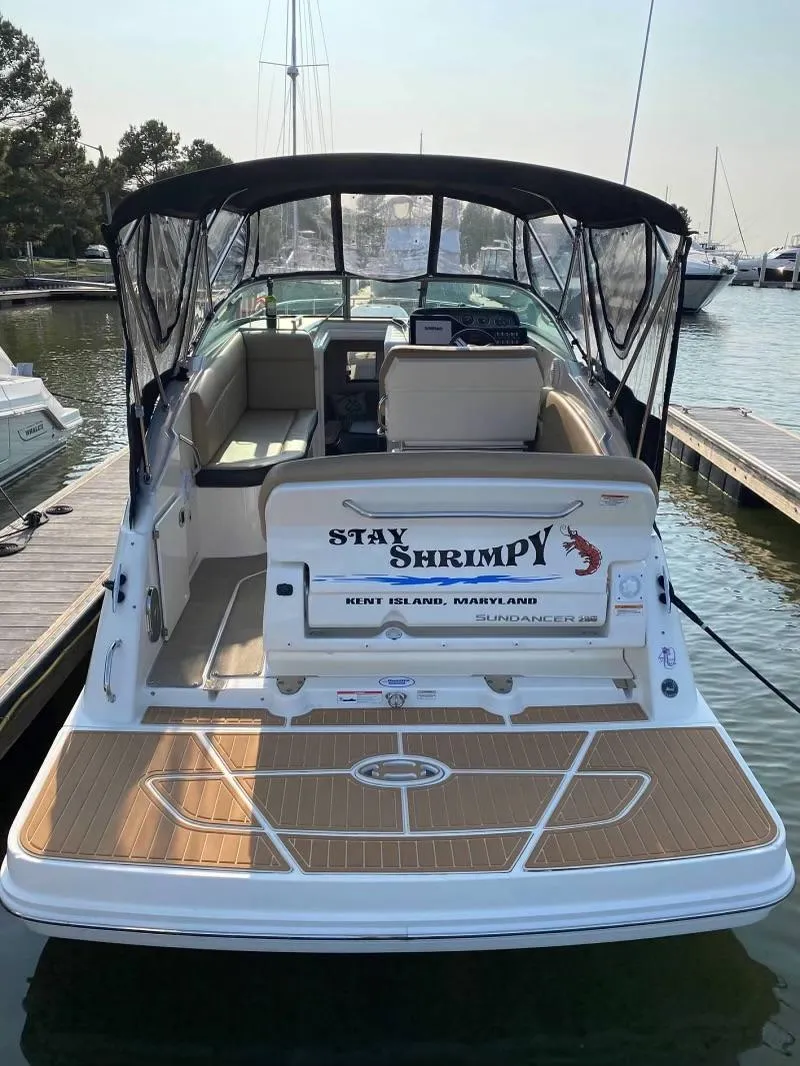 Slide: The Image of 2018 Sea Ray Sundancer 260 boat docked, featuring "Stay Shrimpy" name on the stern. - 12