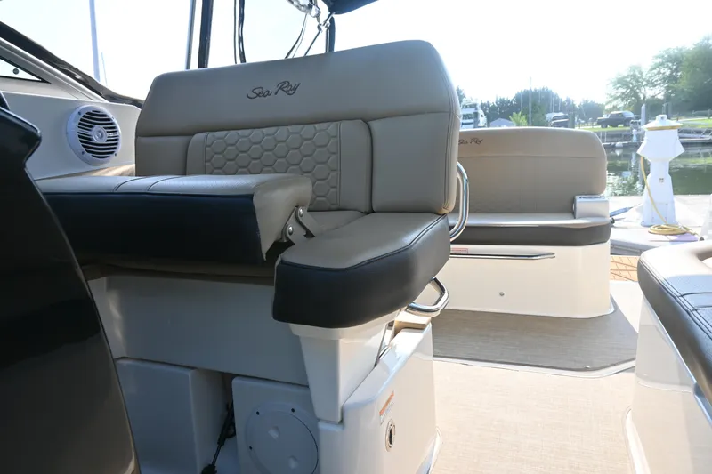Slide: The Image of 2018 Sea Ray Sundancer 260 interior seating with elegant design and waterfront view. - 14