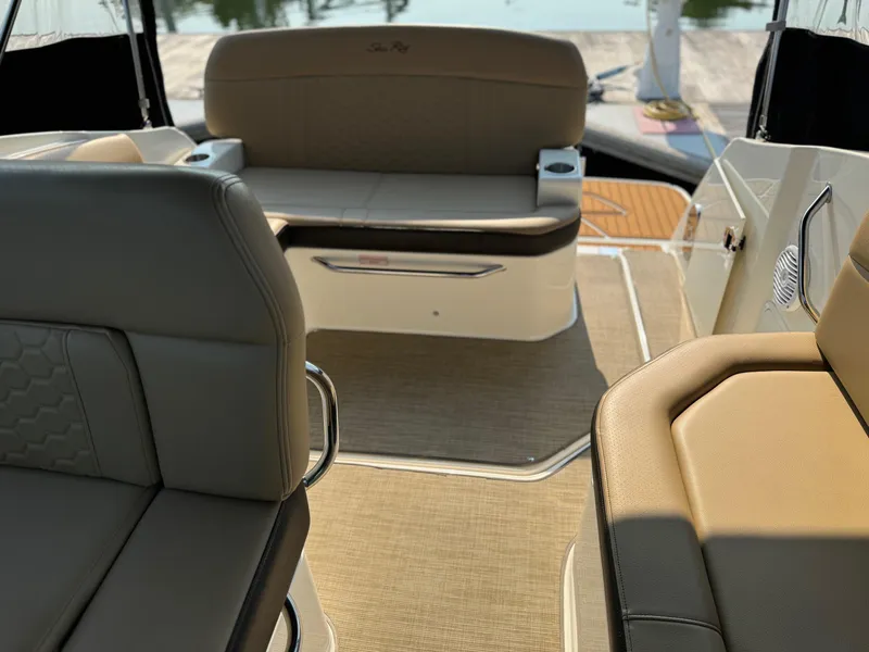 Slide: The Image of Interior of 2018 Sea Ray Sundancer 260 boat with beige seating and carpet. - 15
