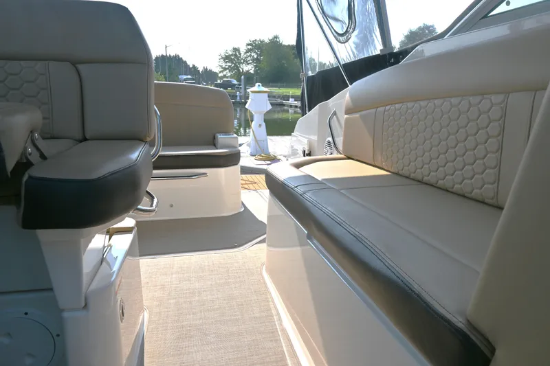 Slide: The Image of Interior view of 2018 Sea Ray Sundancer 260 boat with beige seating. - 16