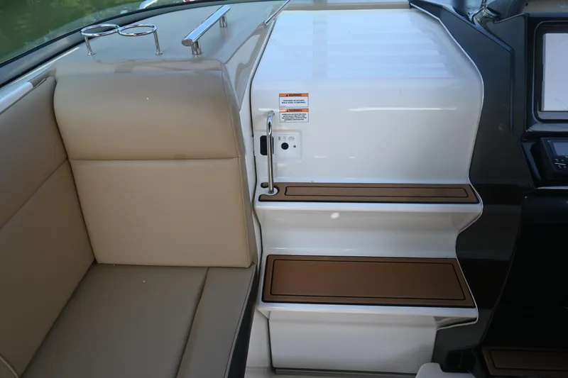 Slide: The Image of 2018 Sea Ray Sundancer 260 interior with beige seating and wooden steps. - 17