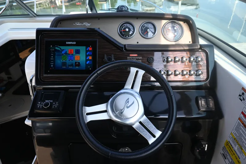 Slide: The Image of 2018 Sea Ray Sundancer 260 helm with steering wheel and control panel. - 22
