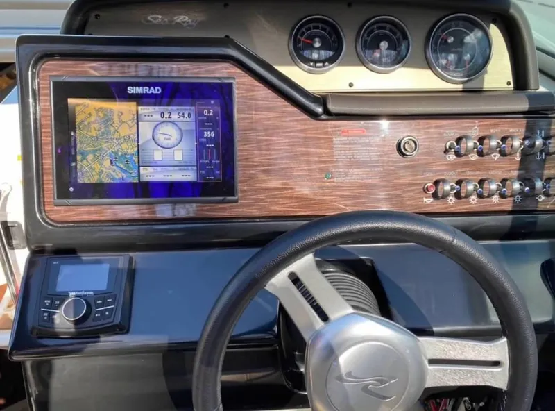 Slide: The Image of 2018 Sea Ray Sundancer 260 dashboard with Simrad navigation system and control panel. - 24