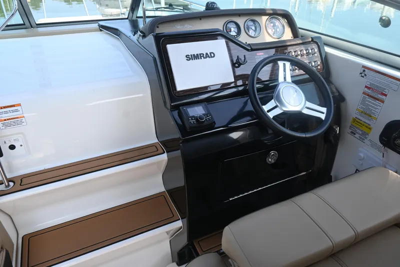 Slide: The Image of 2018 Sea Ray Sundancer 260 helm with Simrad display and modern steering wheel. - 25