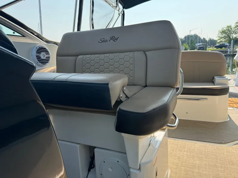 Slide: The Image of 2018 Sea Ray Sundancer 260 boat interior with cushioned seating and elegant design. - 26