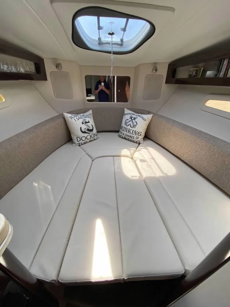 Slide: The Image of 2018 Sea Ray Sundancer 260 cabin interior with skylight and cushions. - 29