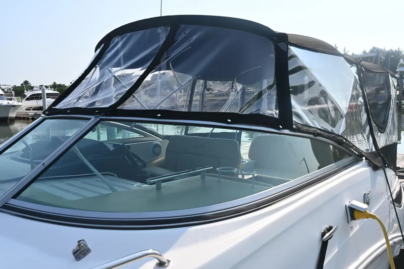 Slide: The Image of 2018 Sea Ray Sundancer 260 with clear canopy, docked at marina. - 5