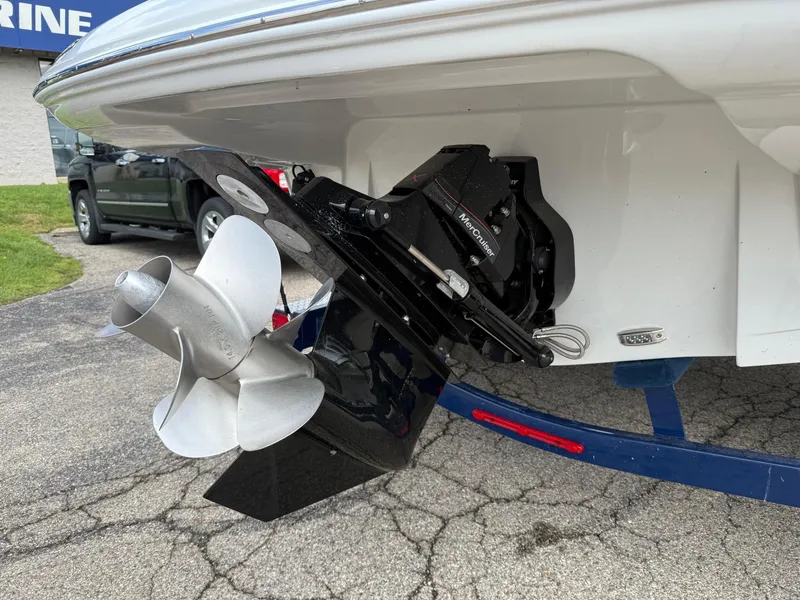 Slide: The Image of 2025 Crownline 290 SS boat stern with propeller and outdrive on trailer. - 2