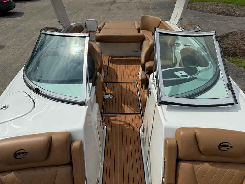 Slide: The Image of 2025 Crownline 290 SS boat with tan leather seats and open windshield. - 5