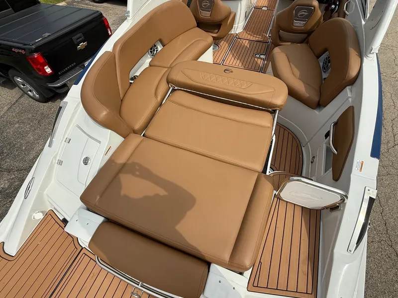 Slide: The Image of 2025 Crownline 290 SS boat interior with tan leather seating and wood accents. - 7