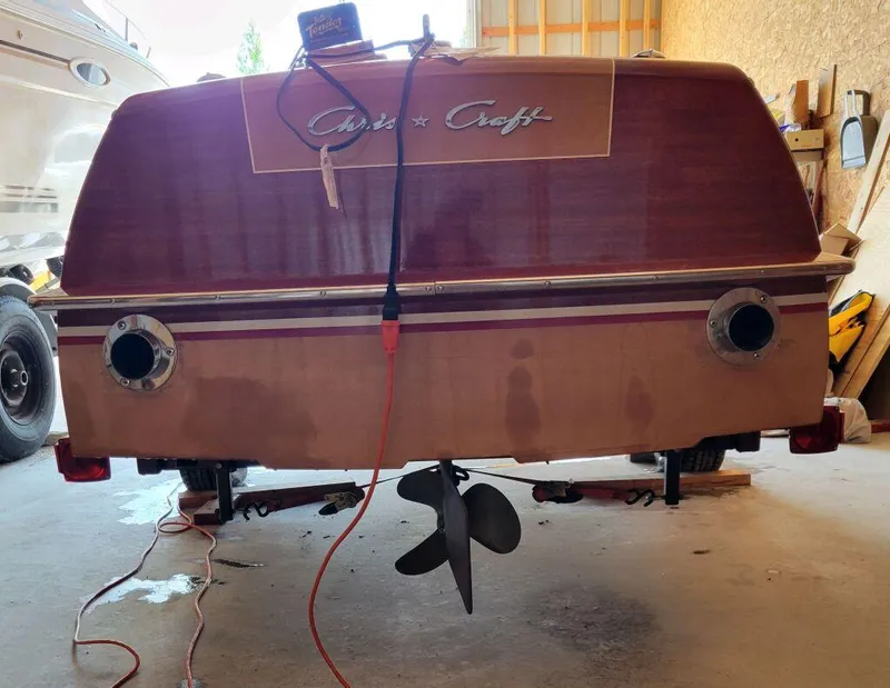 Slide: The Image of 1951 Chris-Craft Riviera 16 boat in a garage, rear view with propeller and cables. - 15