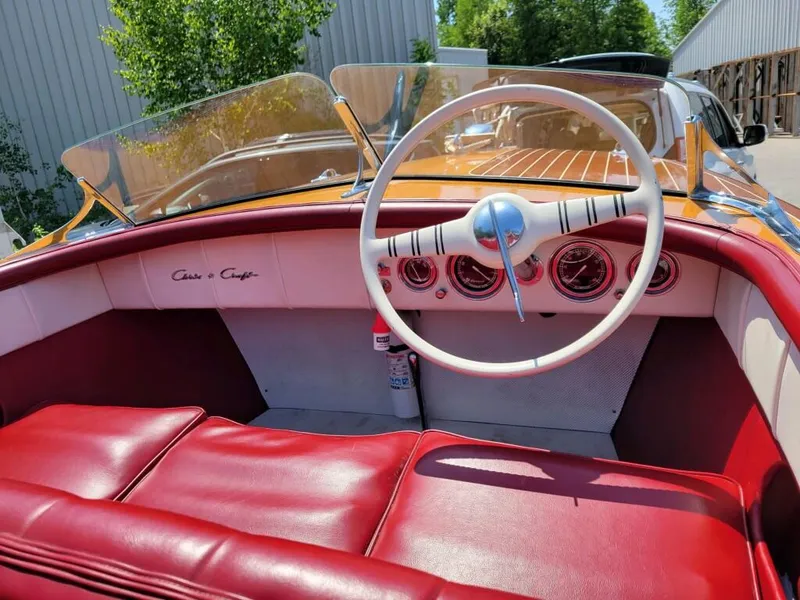 Slide: The Image of 1951 Chris-Craft Riviera 16 boat interior with red leather seats and classic dashboard. - 16